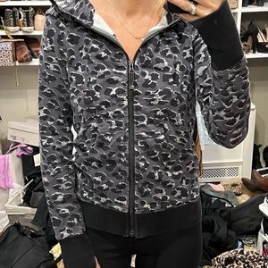 Lululemon leopard print hooded zip up sweatshirt with hand holes and pockets.